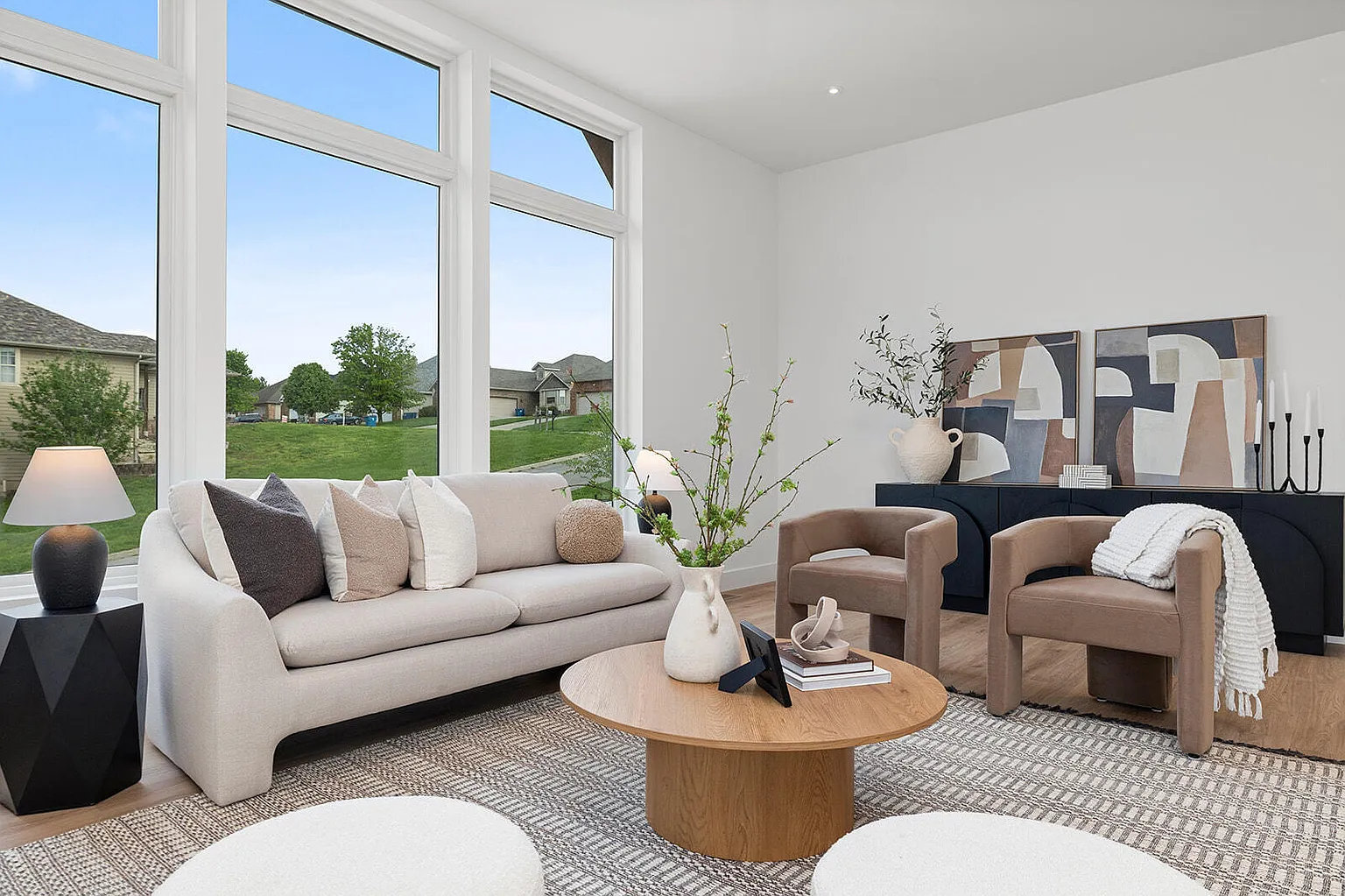 Staged living room couch with two accent armchairs and round coffee table - 2807 S 14th Ave, Ozark, MO