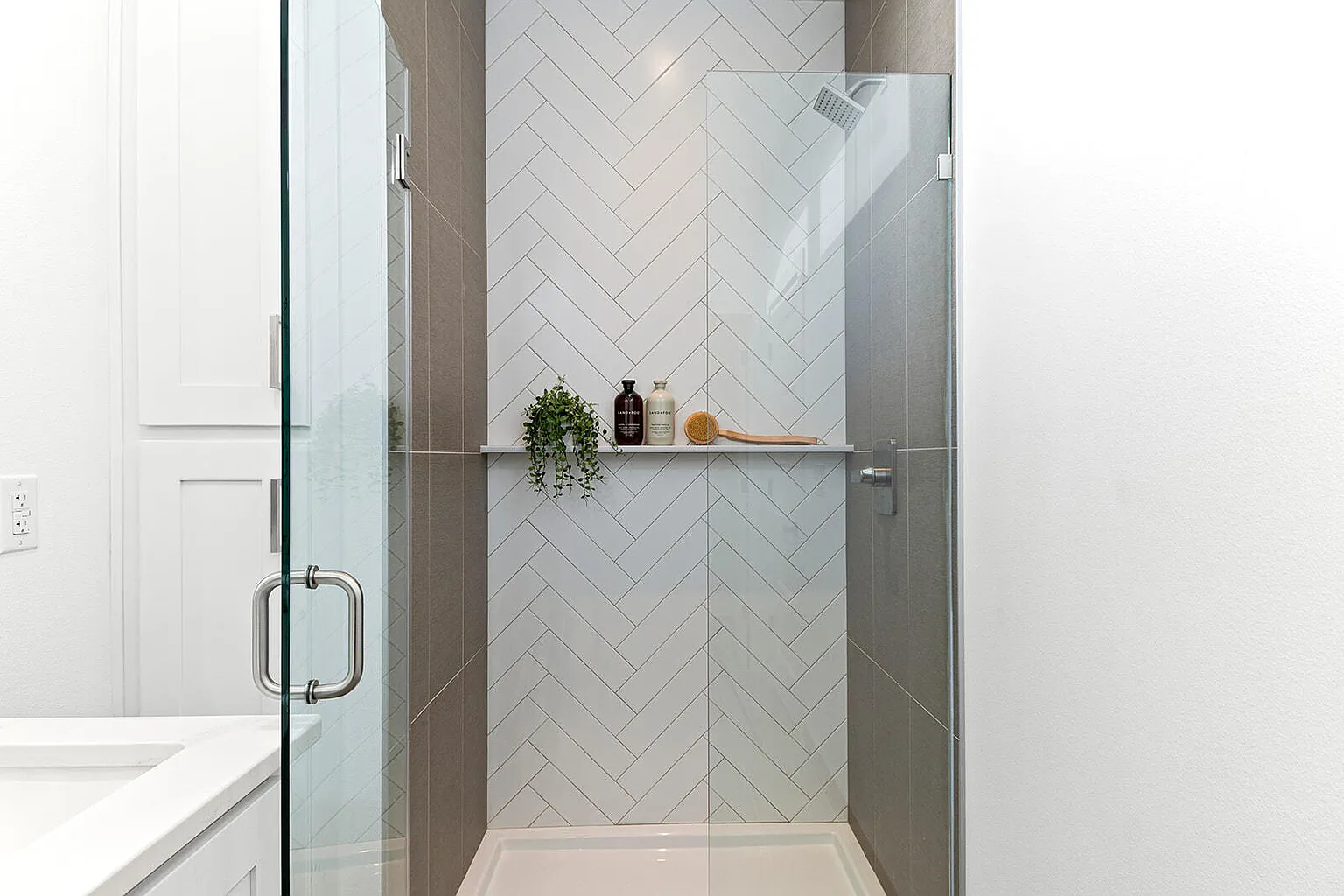 Master bath herringbone tile walk-in shower detail - 2807 S 14th Ave, Ozark, MO