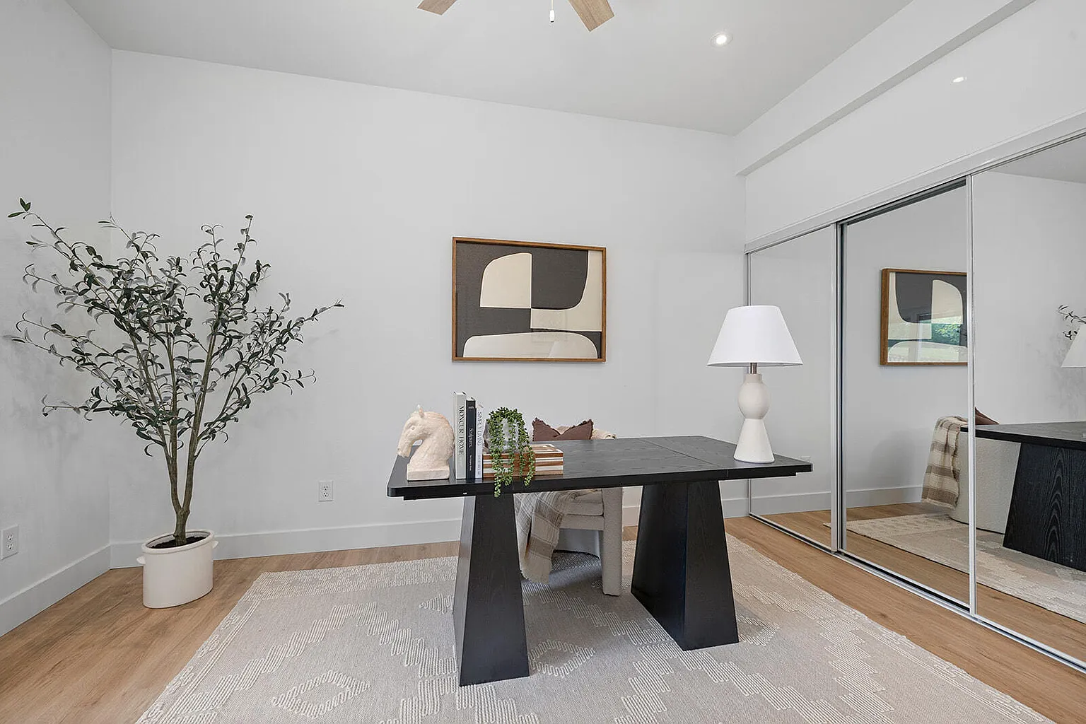 Office staged with black desk and mirrored closet doors - 2807 S 14th Ave, Ozark, MO