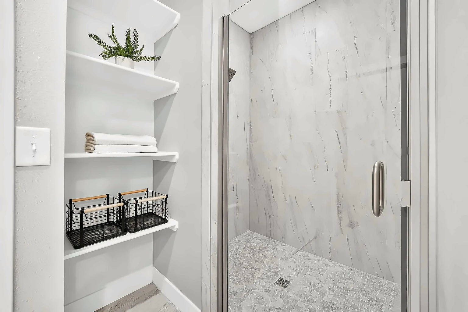 Marble-tile walk-in glass shower with open towel shelving after vacant home staging at 5048 Swale, Springfield, MO