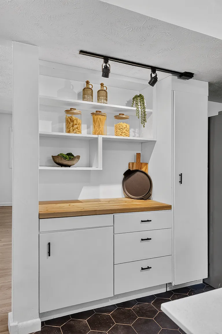 Kitchen pantry with open shelving, butcher block counter and track lighting styled for listing photos - Florence Ave, Springfield, MO
