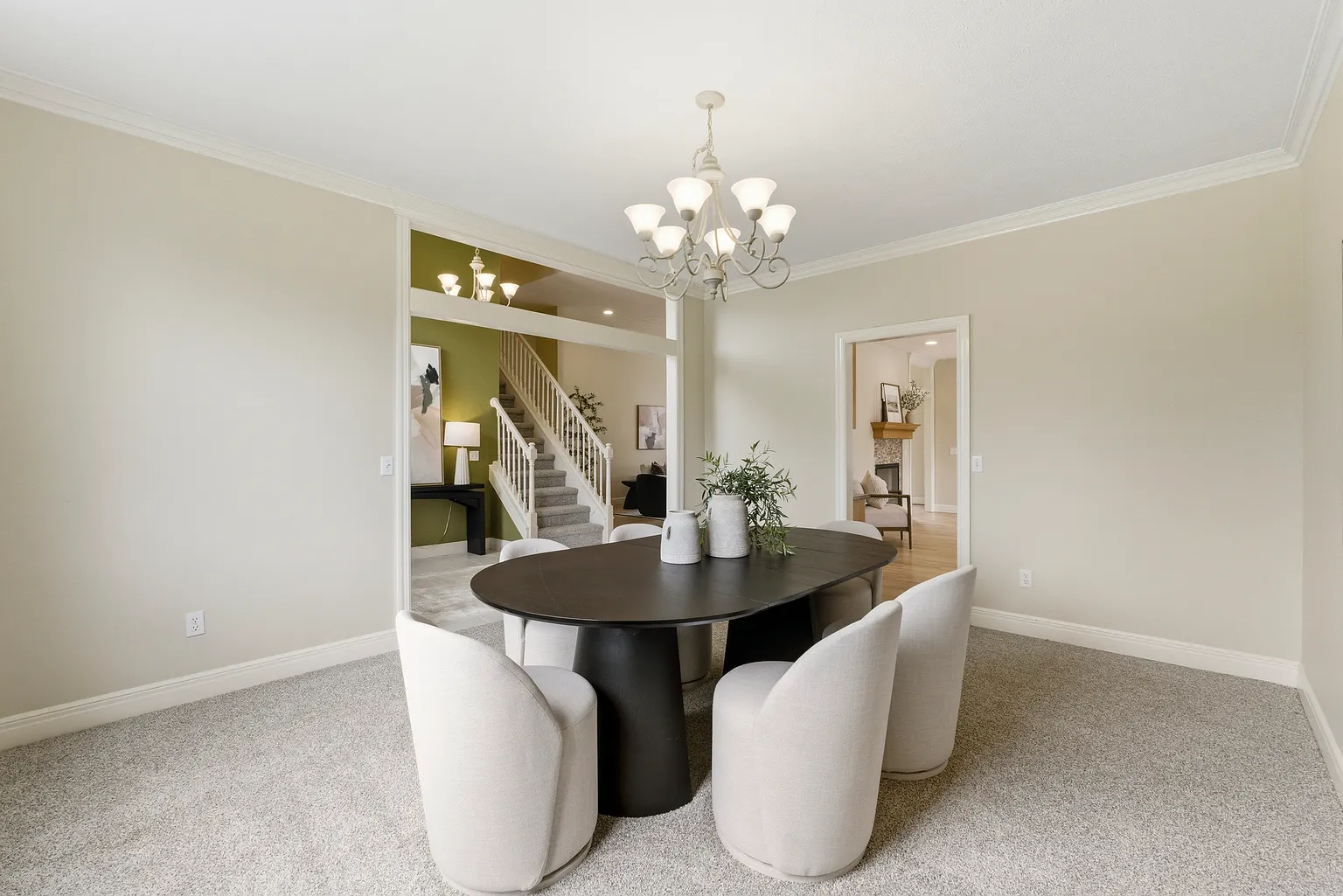 Formal dining room with view to staircase and entry after home staging - Gaslight Drive, Springfield, MO