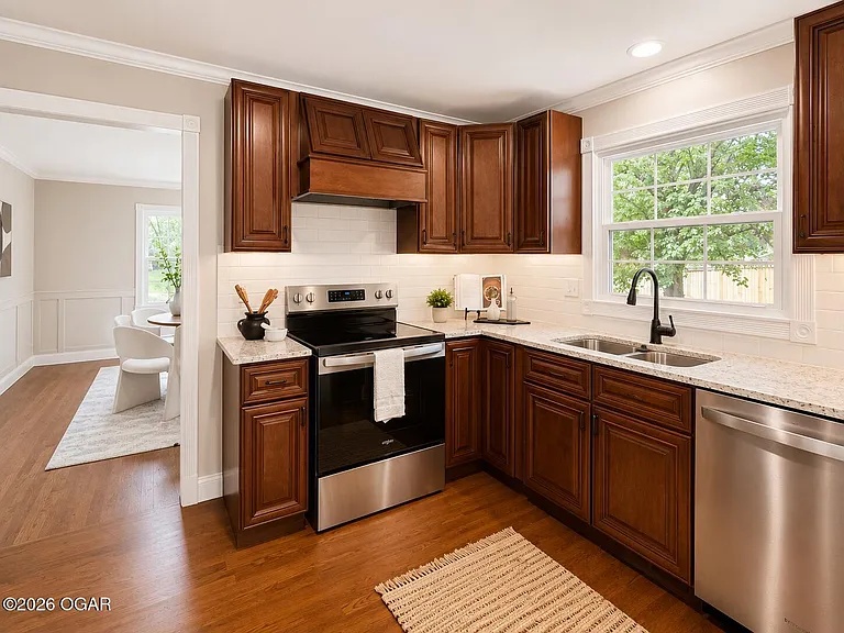 Kitchen with dark wood cabinets after home staging on West Ellison Drive, Springfield, MO